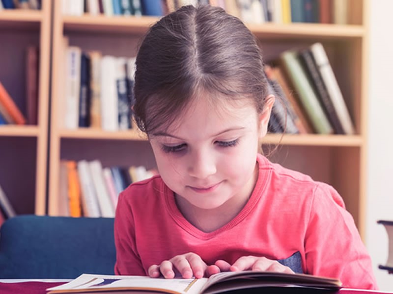 Photograph of a girl reading a book